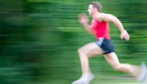 Young man running, slow shutter speed, motion blur